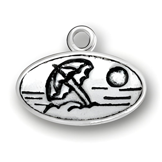Beach Scene Charm in sterling silver featuring an umbrella, sun, and waves in an oval design.