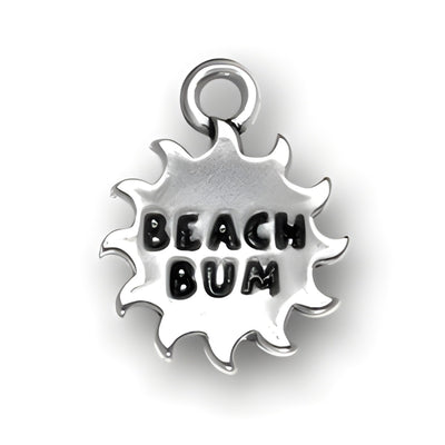 Beach Bum Charm made of sterling silver, featuring a sunburst design with the words 'BEACH BUM' in bold letters.