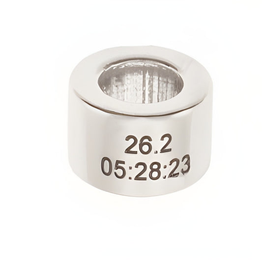 Personalized Round Runner Bead by Charm Factory, made of silver, engraved with '26.2' and '05:28:23'.