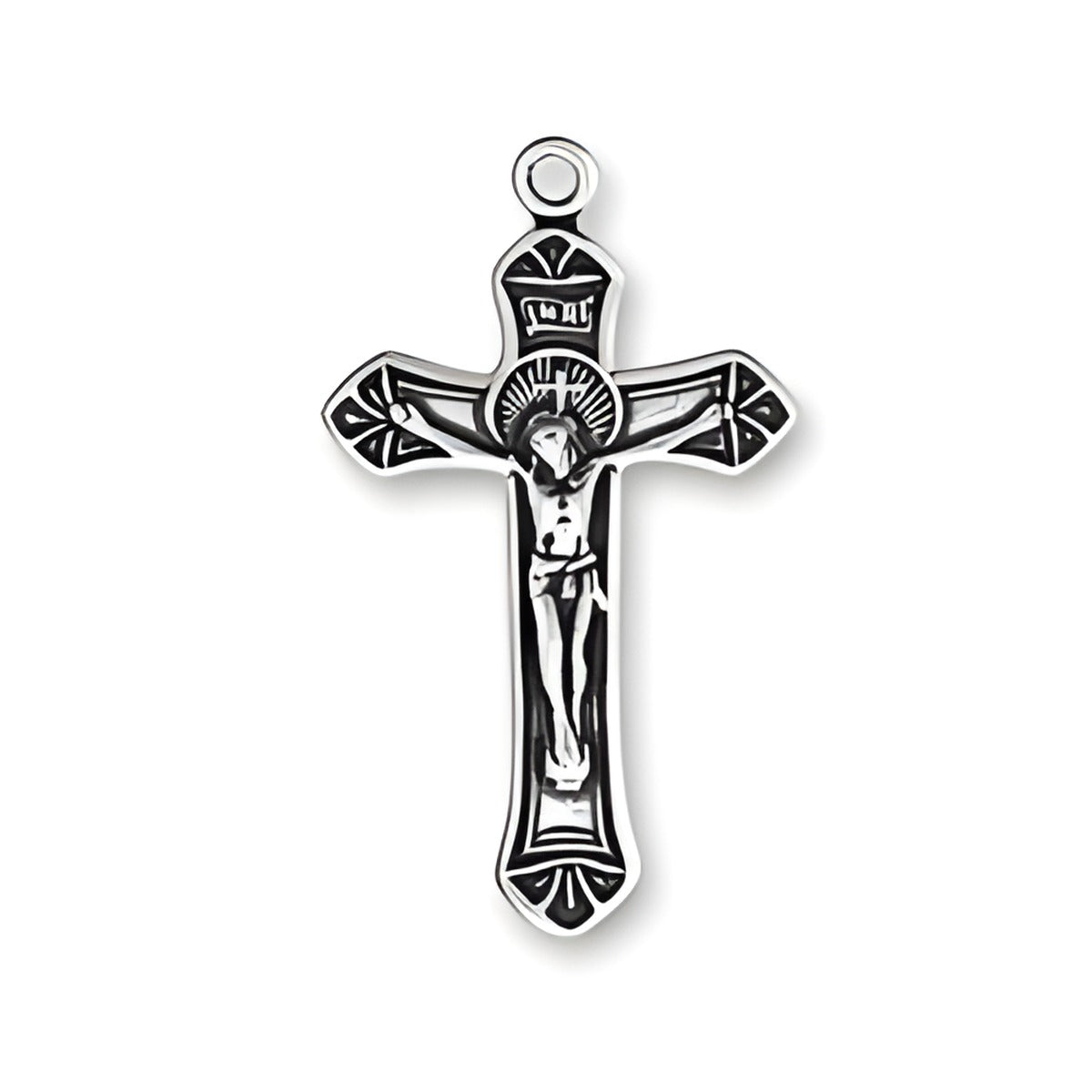 Small ornate crucifix charm made of sterling silver, featuring detailed design with figure of Christ on the cross.