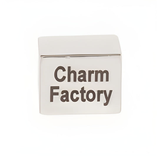 Small personalized rectangle runner bead made of sterling silver, featuring the engraved text 'Charm Factory'.