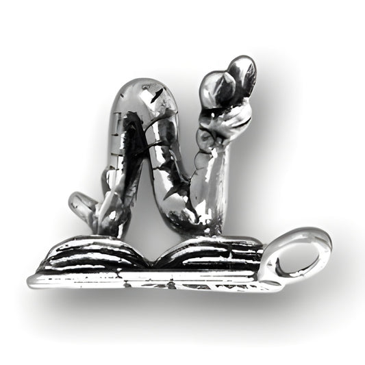 Sterling Silver Bookworm Charm featuring a whimsical worm reading a book, detailed and polished design.